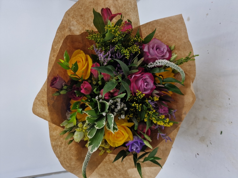 Handtied Bouquet in various fresh flowers in yellows, pinks, and other pastel colours